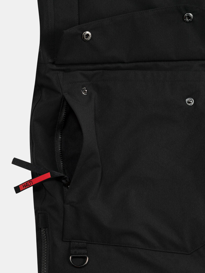 Lähikuva Halti 1976 Down Parka Unisex-taskusta, jossa on napit, vetoketju ja punainen Halti-vetoketju.