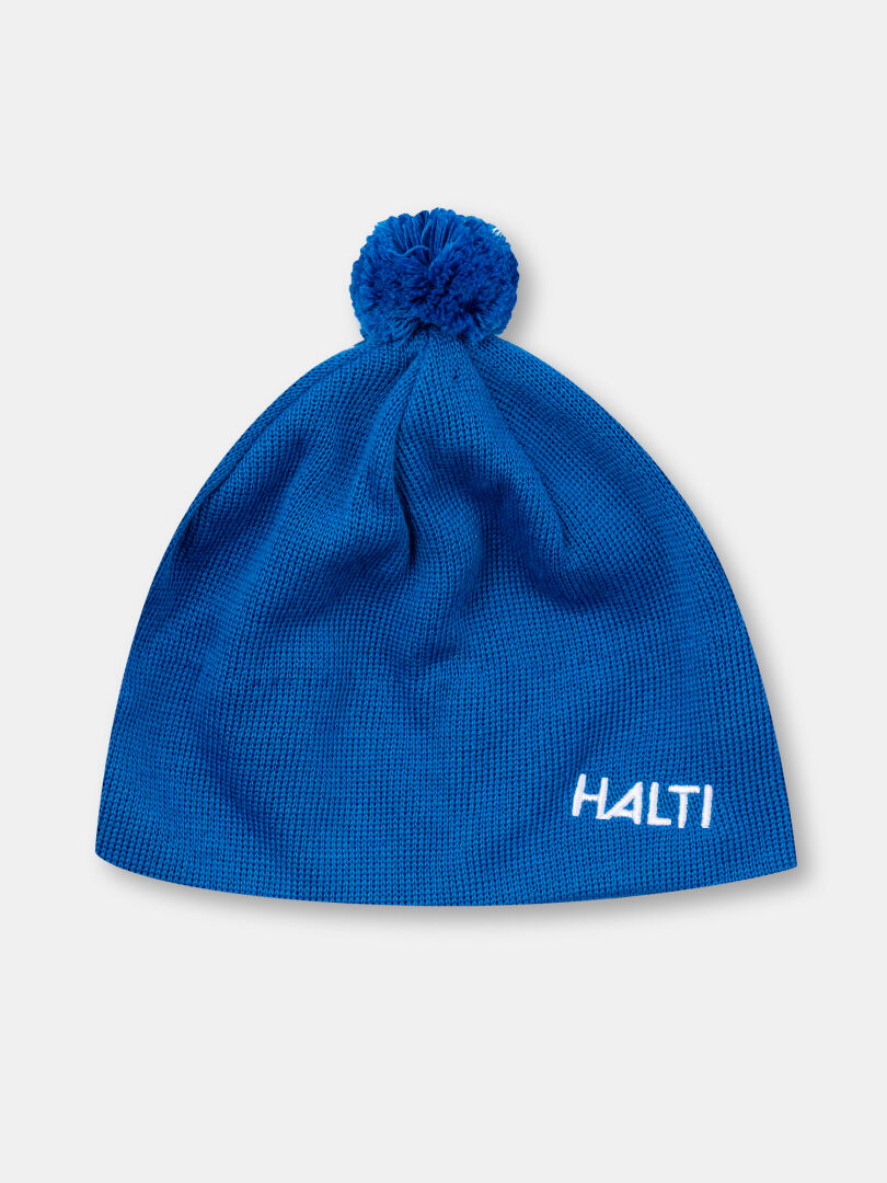 Halti Peesi II Pipo: sininen merinovillainen pipo, jossa on pompsupää ja valkoinen HALTI-kirjonta edessä.