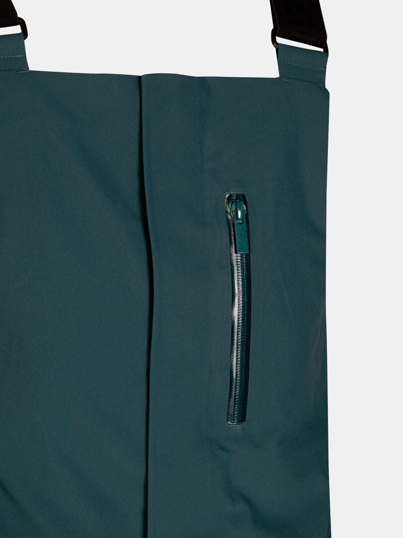Tummanvihreät Rizle 3L DX Lasketteluhousut – unisex-lasketteluhousut, joissa on pystysuora vetoketjullinen rintatasku ja mustat olkaimet.