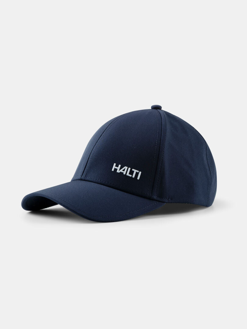 Haltin Mattas Baseball-lippis on tummansininen, UPF 50+, ja siinä on valkoinen 