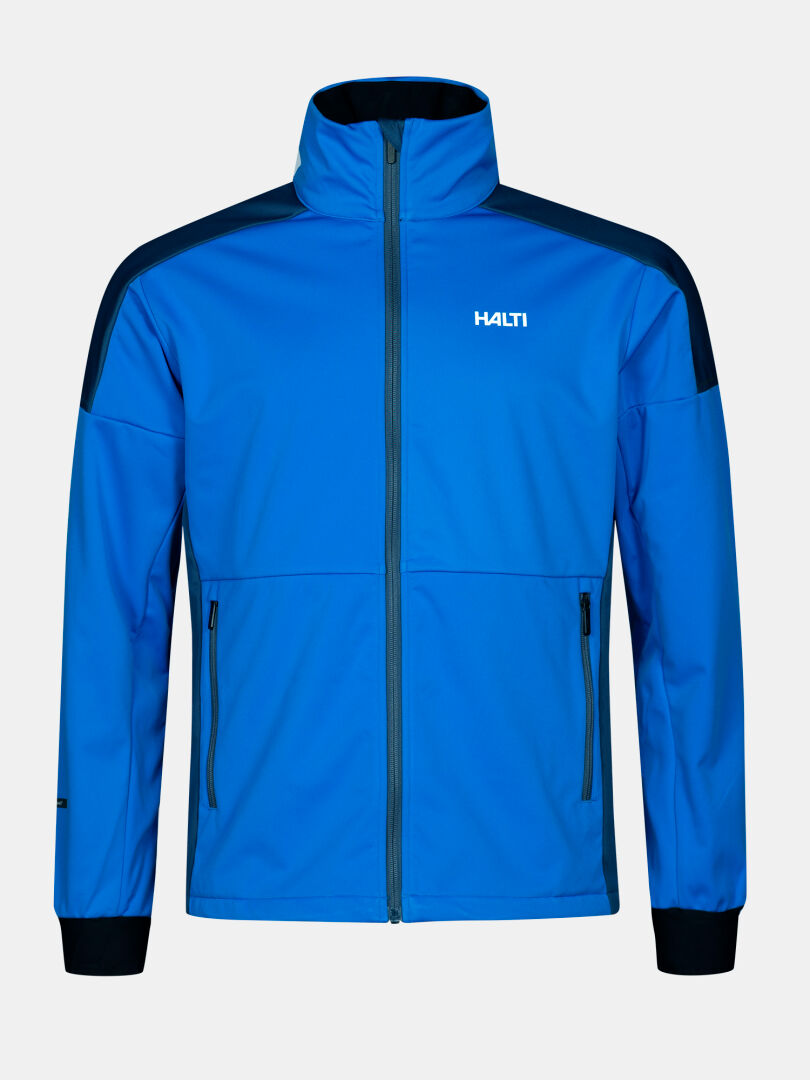 Halti Huuru Maastohiihtopuku Miesten on sininen softshell-takki, jossa on mustat olkapäät, vetoketjutaskut ja logo vasemmalla rinnassa.