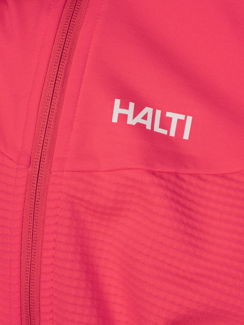 Lähikuva vaaleanpunaisesta Halti HeatGrid Välitakki Naisten vaatteesta, jossa on vetoketju ja valkoinen Halti-logo rinnassa.